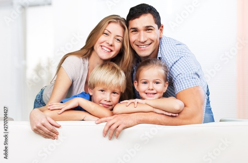 Beautiful smiling family in room on couch