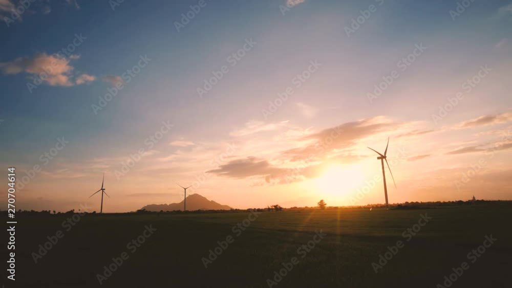 Wind turbine farm or windmill on golden sunset sky in summer day. High-quality stock footage of wind turbine or windmill for clean energy concept. Energy Production with clean and Renewable Energy Wind turbine farm or windmill on golden sunset sky in summer day. High-quality stock footage of wind turbine or windmill for clean energy concept. Energy Production with clean and Renewable Energy