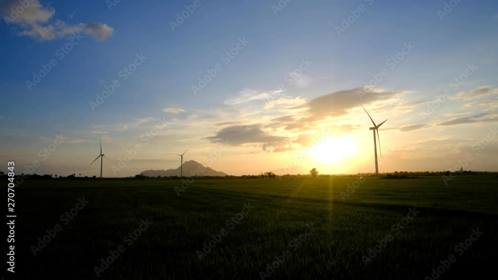 Wind turbine farm or windmill on golden sunset sky in summer day. High-quality stock footage of wind turbine or windmill for clean energy concept. Energy Production with clean and Renewable Energy Wind turbine farm or windmill on golden sunset sky in summer day. High-quality stock footage of wind turbine or windmill for clean energy concept. Energy Production with clean and Renewable Energy
