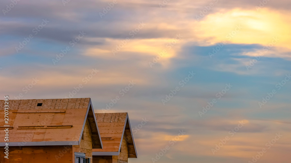 Panorama frame Close up of a house under construction against cloudy sky at sunset