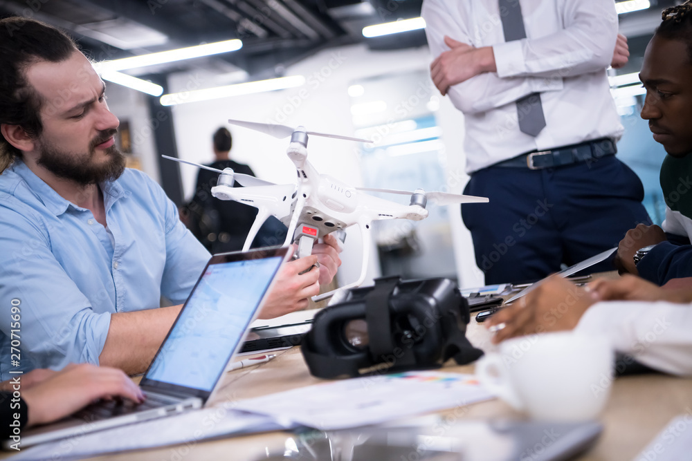 multiethnic business team learning about drone technology multiethnic business team learning about drone technology