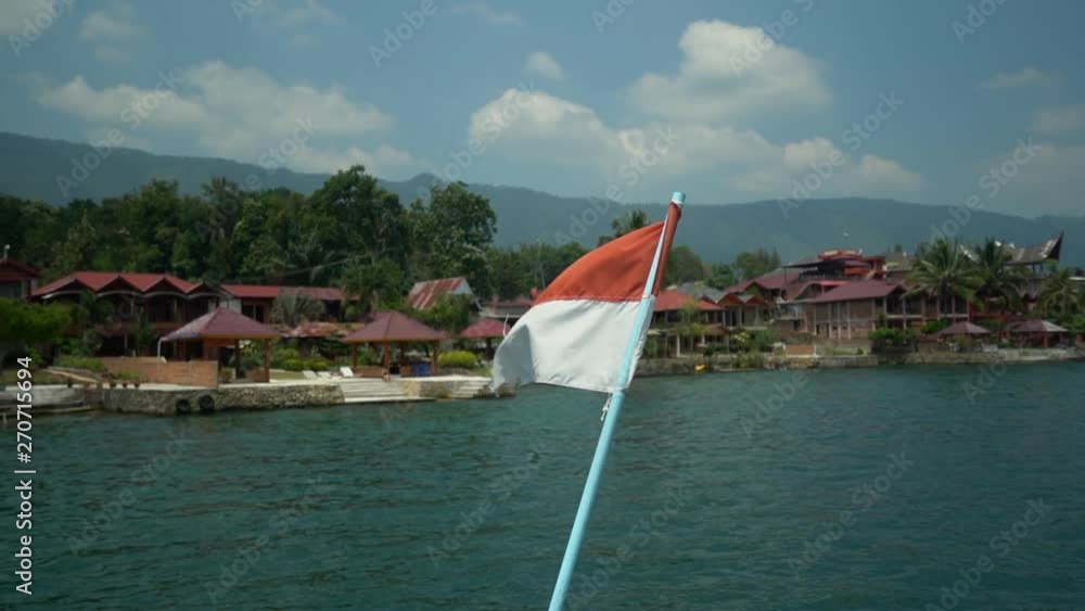 custom made wallpaper toronto digitalSlow motion of the Indonesia flag blowing in the wind on a ferry boat crossing Lake Toba with traditional resorts in the background in North Sumatra.