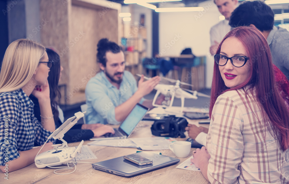 redhead business woman learning about drone technology redhead business woman learning about drone technology