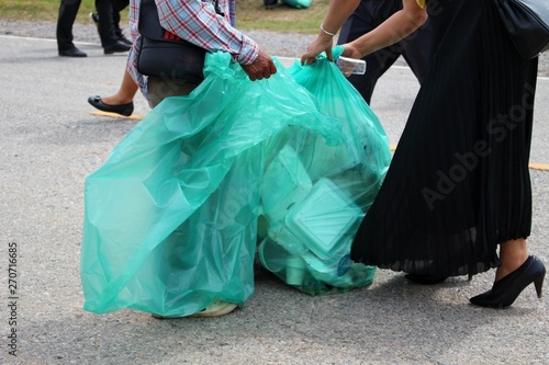 Men and women are helping to collect garbage