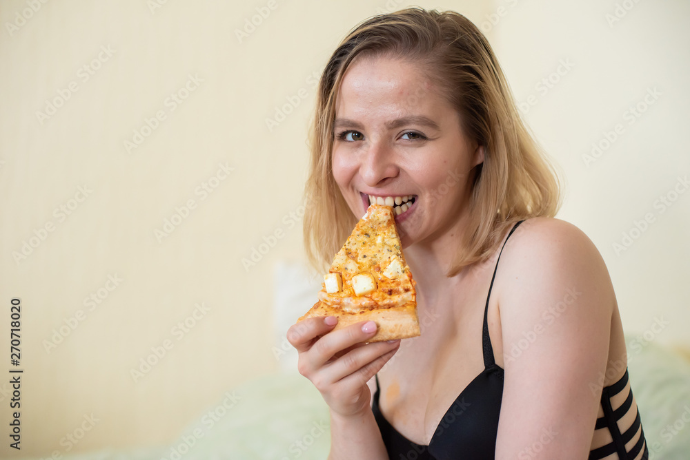 European girl with short hair posing with pieces of delicious pizza. European girl with short hair posing with pieces of delicious pizza.