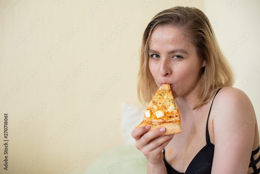 European girl with short hair posing with pieces of delicious pizza. European girl with short hair posing with pieces of delicious pizza.