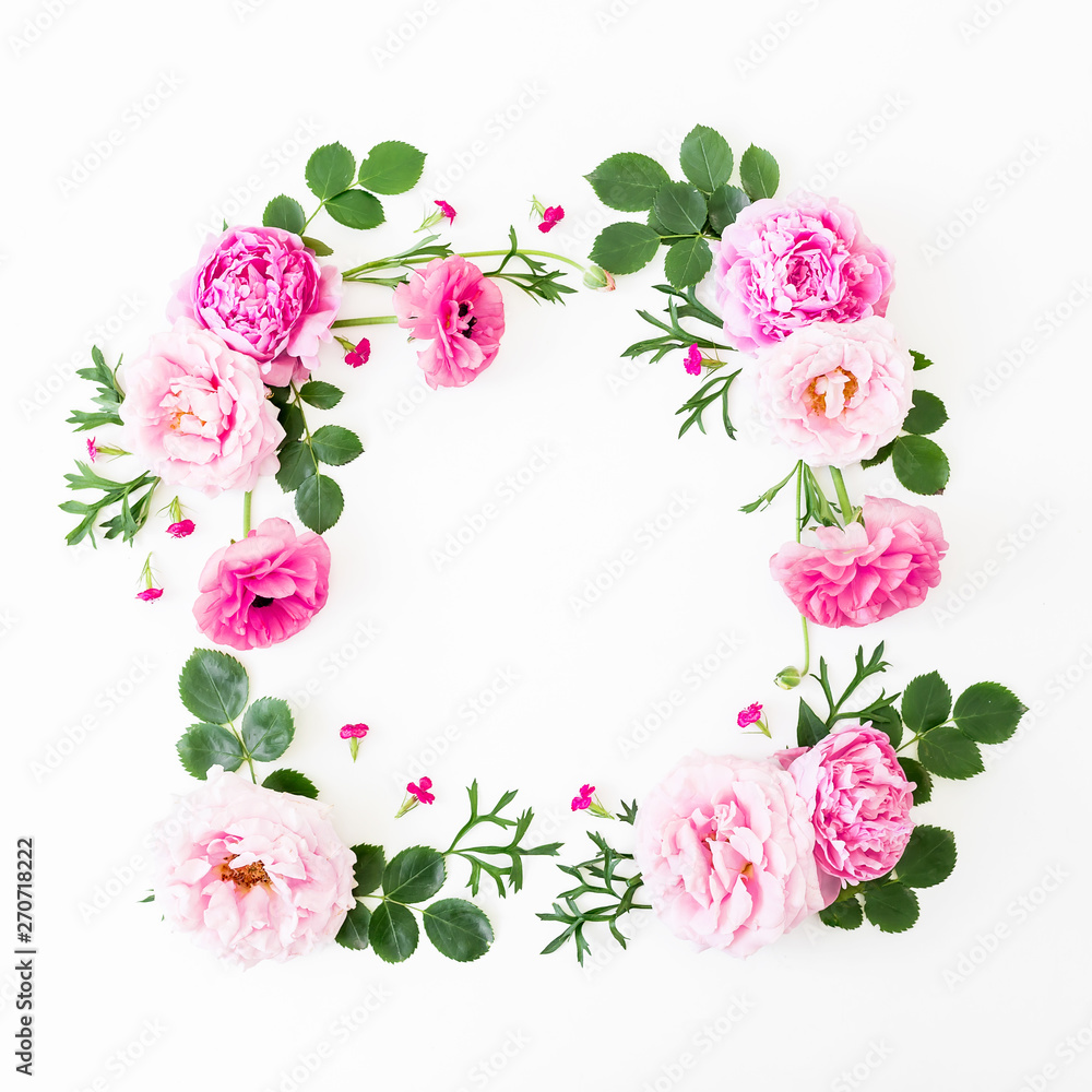 Floral frame of pink roses, peonies and leaves on white background. Flat lay, top view. Summer time flowers composition