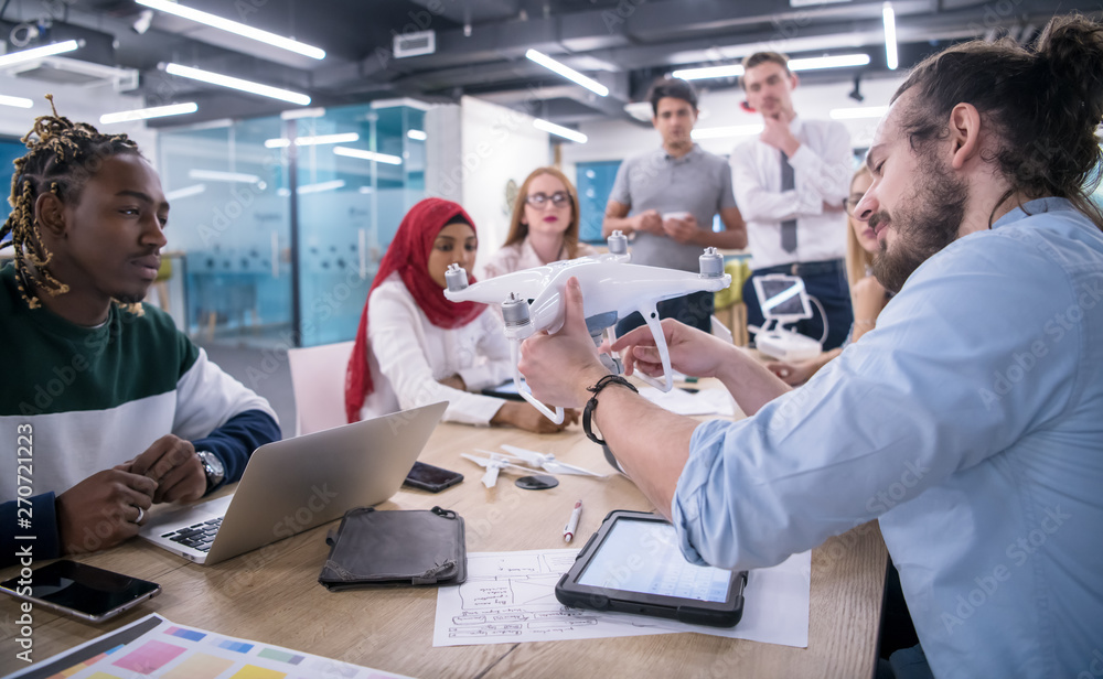 Obraz premium multiethnic business team learning about drone technology