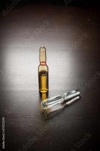 Medication ampoules for Intravenous injections on wooden background, medical concept