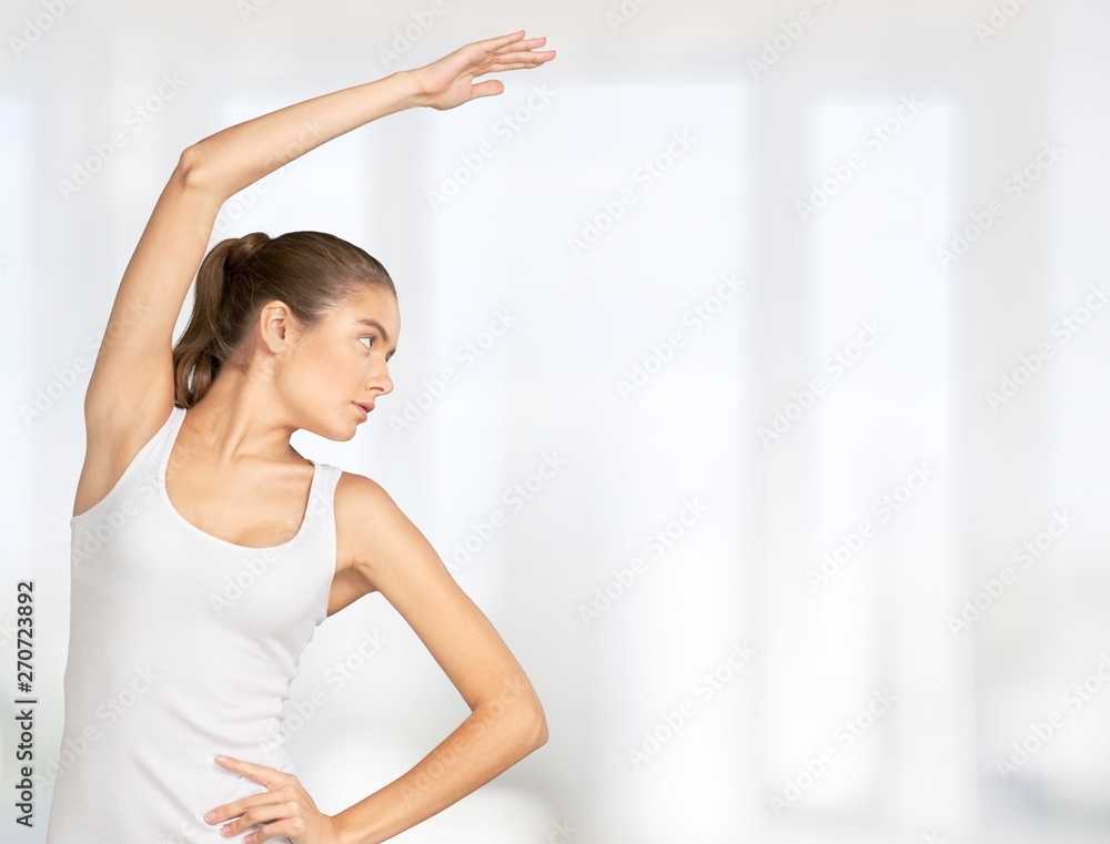 Close-up attractive young woman holding dumbbell on blurred background Close-up attractive young woman holding dumbbell on blurred background