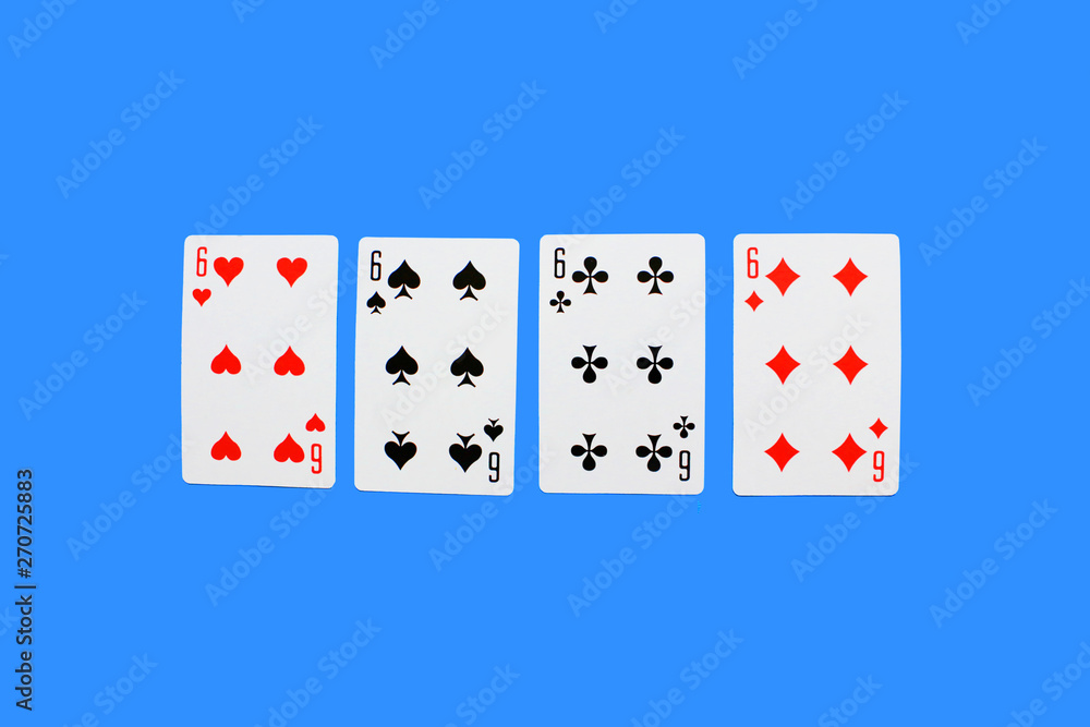 Four Playing Cards Isolated on blue Background. Close-up of playing cards.Showing Six from Each Suit - Hearts, Clubs, Spades and Diamonds. Space for text. Playing cards isolated on blue background. Four Playing Cards Isolated on blue Background. Close-up of playing cards.Showing Six from Each Suit - Hearts, Clubs, Spades and Diamonds. Space for text. Playing cards isolated on blue background.