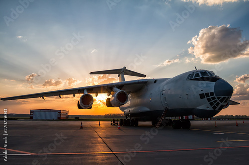 Wide body transport cargo plane at airport apron in the morning sun