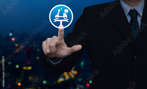 Businessman pressing service fix motorcycle with wrench tool flat icon over blur colorful night light city tower, Business repair motorbike service concept