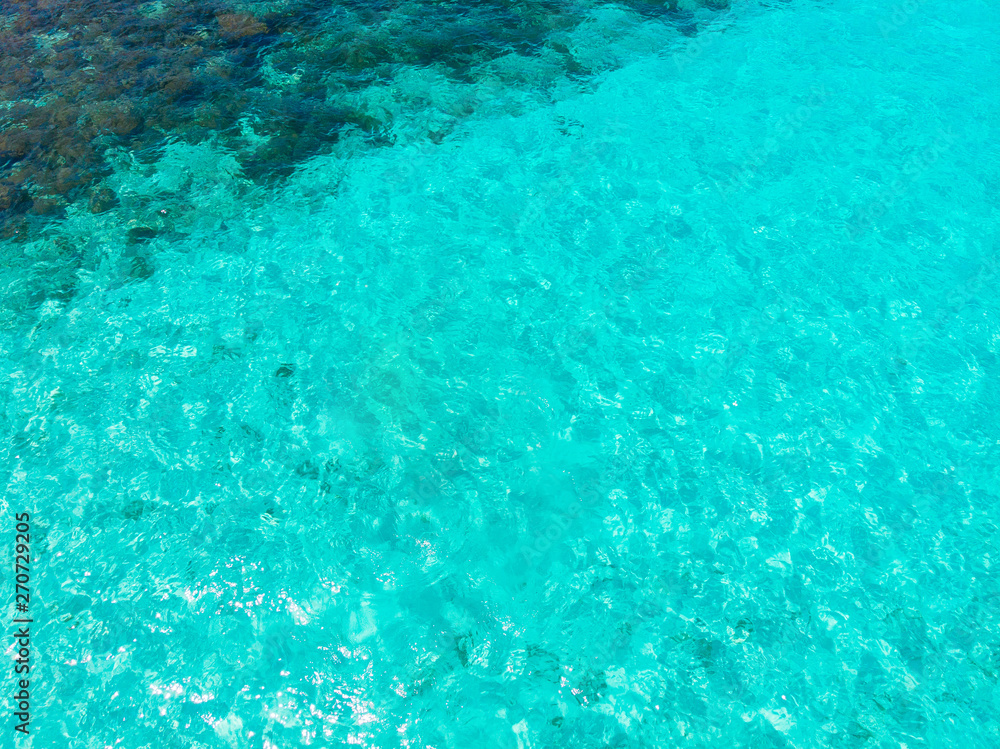 Background blue turquoise sea with coral reef. Top view of Maldives