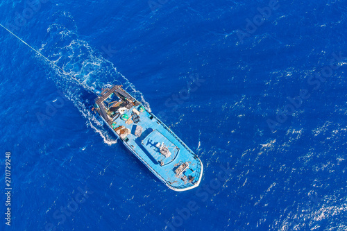 Bulk boat fishing in blue sea. Aerial top view © Parilov