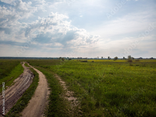 Green field with road path that is split. Kiev, Ukraine