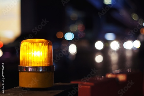 Yellow orange siren light rotary warning light in construction side safety sign, installed beside road