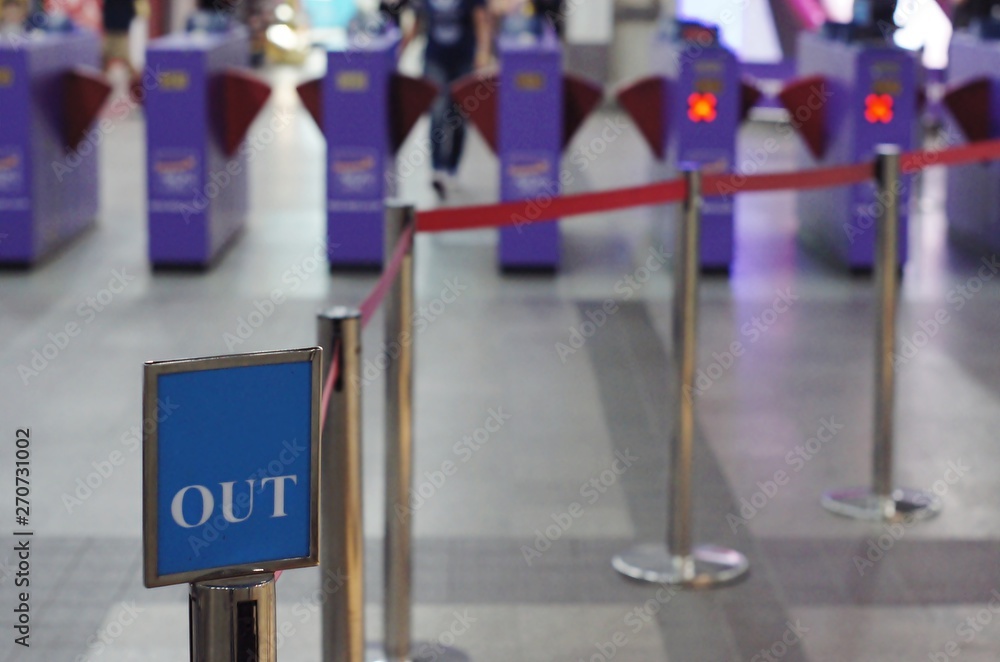 Obraz premium Entry / Exit sign against Rope Barrier Stanchion Queue Rope Barrier Posts Stands Crowd Control