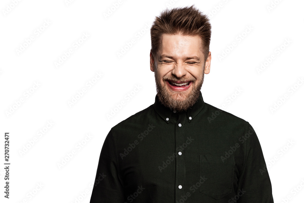 Portrait of laughing young man smiling with closed eyes. Fashionably dressed in black shirt guy in good mood in studio. Copy space in left side. Happiness concept. Isolated on white Portrait of laughing young man smiling with closed eyes. Fashionably dressed in black shirt guy in good mood in studio. Copy space in left side. Happiness concept. Isolated on white