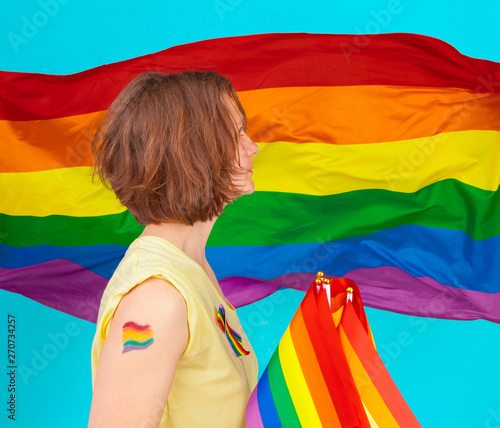 Rainbow flag. Woman holding and waving large LGBT flag