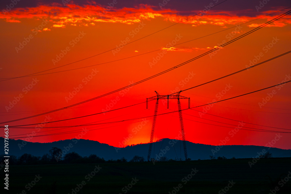 Red sky and the electric pylons