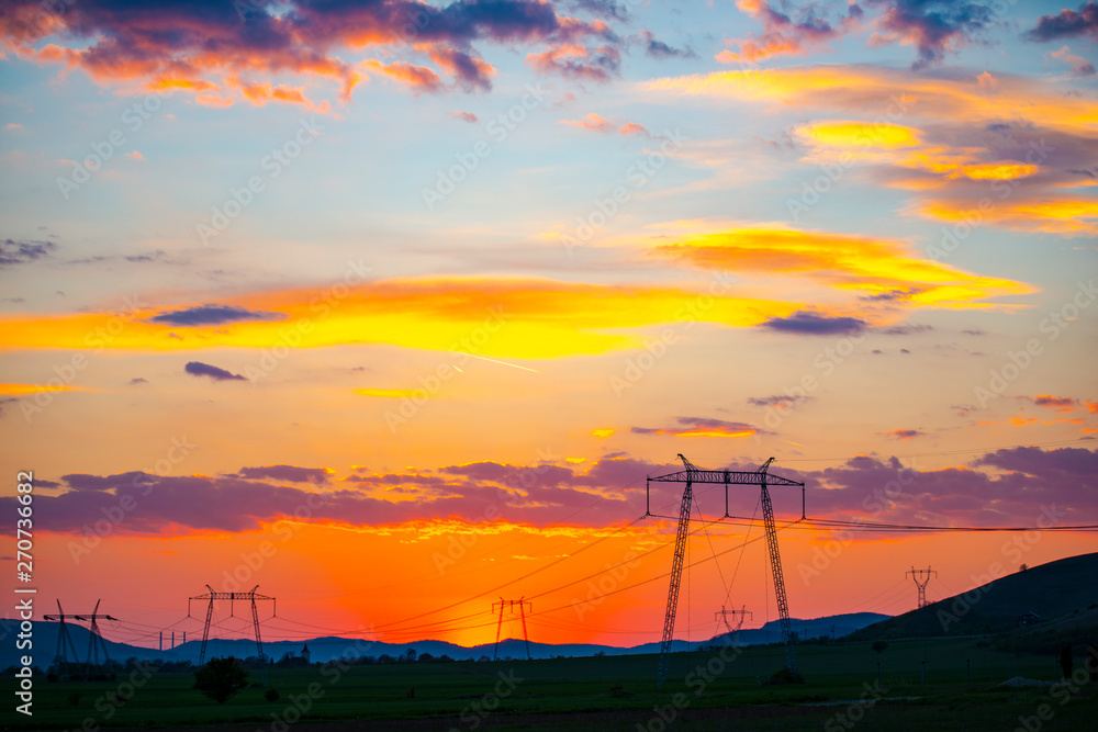 Red sky and the electric pylons