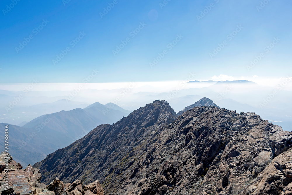 Mountain summit view with landscape of Andes and Aconcagua on clear day in La Campana National park in central Chile, South America