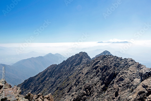 Mountain summit view with landscape of Andes and Aconcagua on clear day in La Campana National park in central Chile, South America