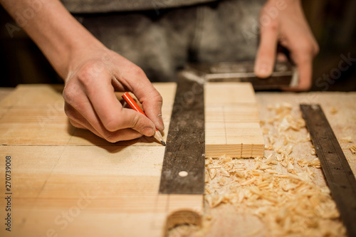 Wallpaper Mural Woodwork and furniture making concept. Carpenter in the workshop marks out the details of the furniture cabinet using a setsquare close up Torontodigital.ca