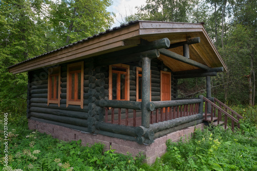 Wooden house in the forest in the summer evening
