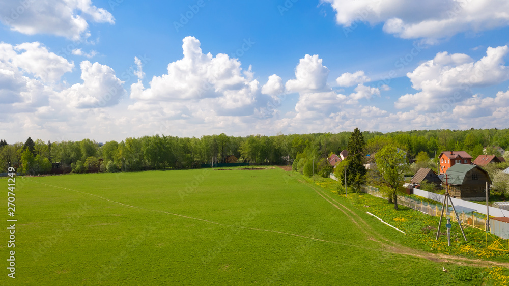 Top view of a plot of agricultural field and a city in the distance Top view of a plot of agricultural field and a city in the distance
