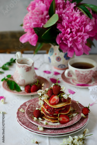 Pancakes with acacia flowers and strawberry chia sauce