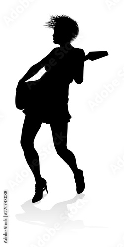 A female guitarist musician in detailed silhouette playing her guitar musical instrument.