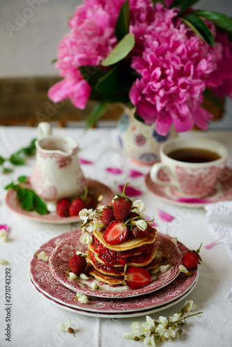 Pancakes with acacia flowers and strawberry chia sauce