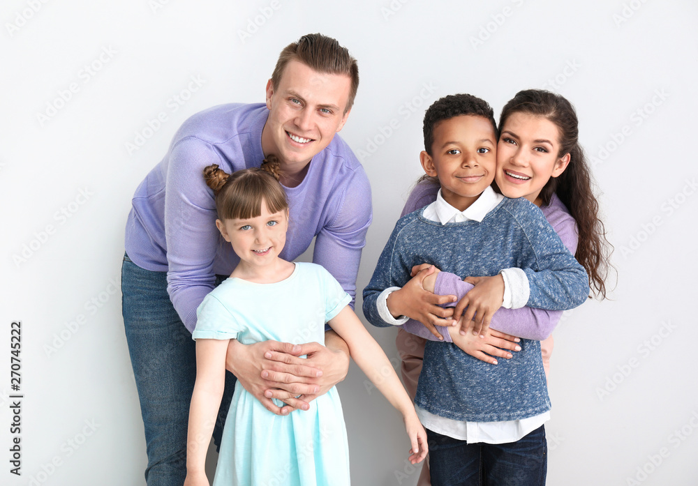 Happy couple with little adopted children on white background Happy couple with little adopted children on white background