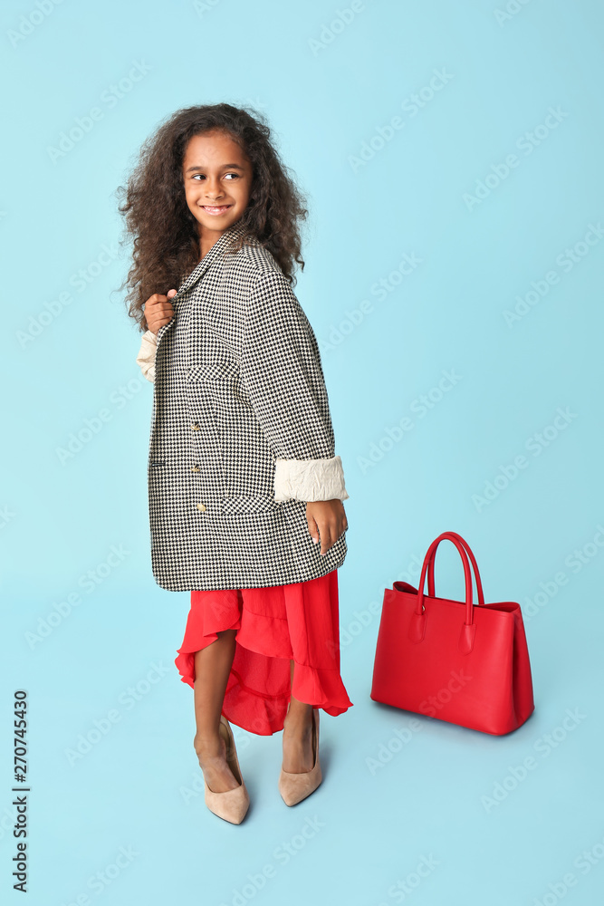 Stylish African-American girl in oversize clothes on color background Stylish African-American girl in oversize clothes on color background