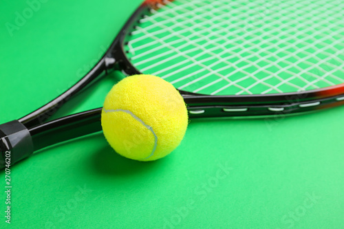 Tennis racket and ball on color background, closeup © Pixel-Shot