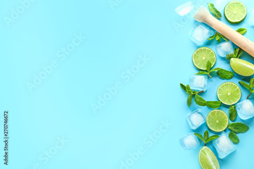 Fresh lime  ice cubes and mint leaves on color background