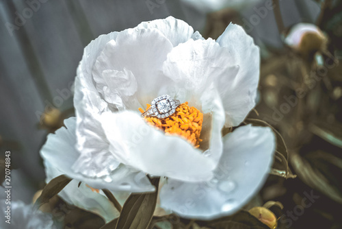 closeup of white flower engagement ring