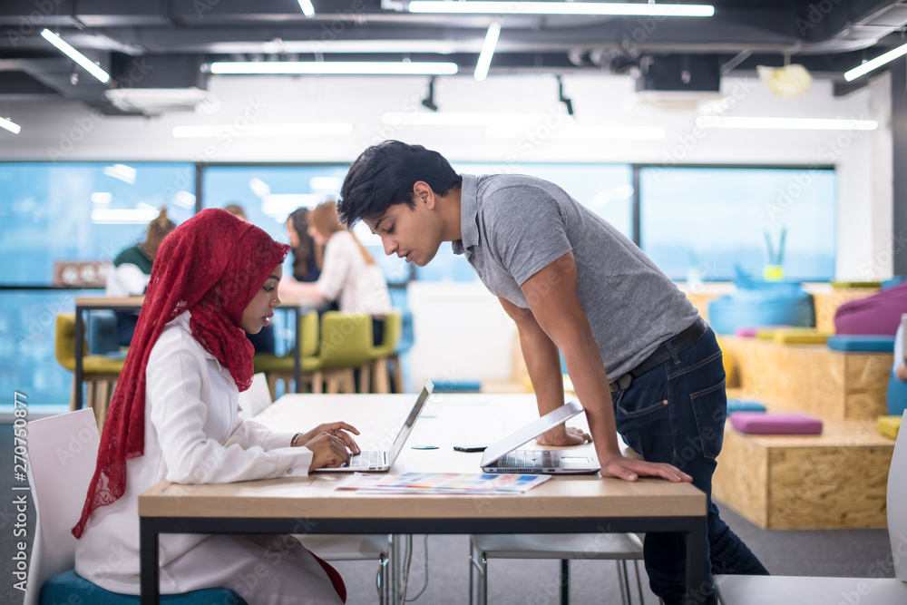 black muslim business woman having a meeting with her indian male colleague black muslim business woman having a meeting with her indian male colleague