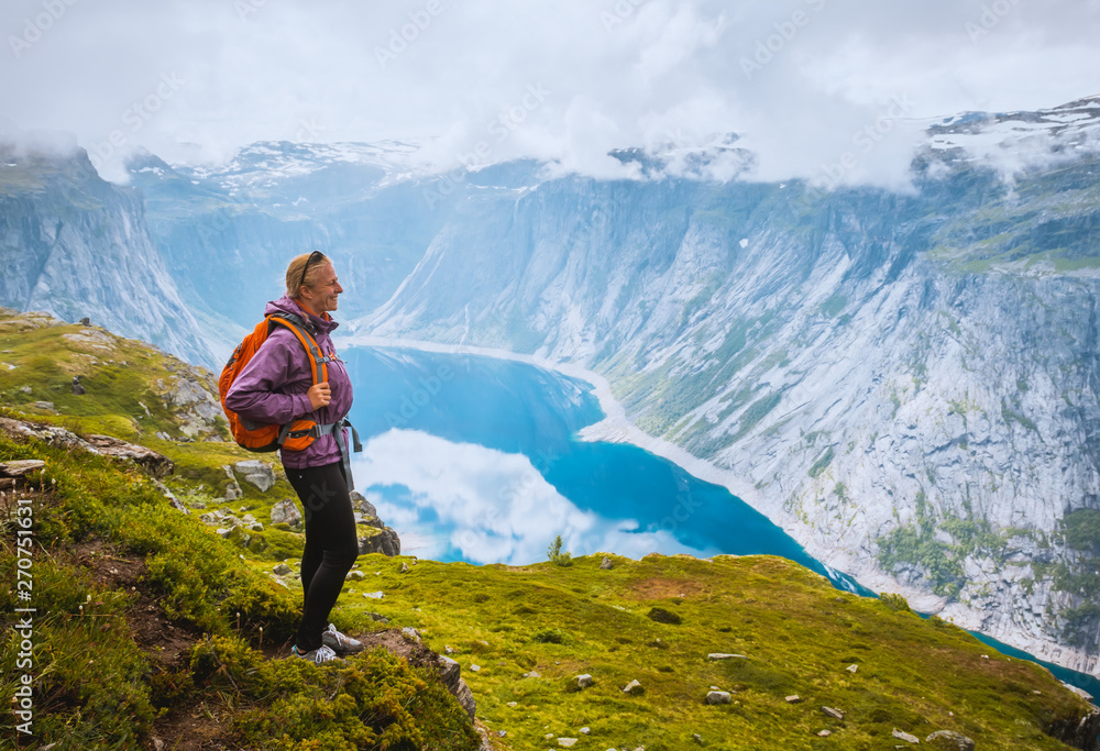 Norway hike. Sporty woman on top of rock near Trolltunga