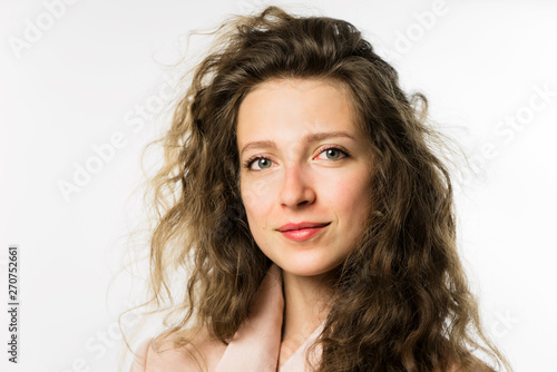 pretty girl with long curly hair in a pink jacket on a white background