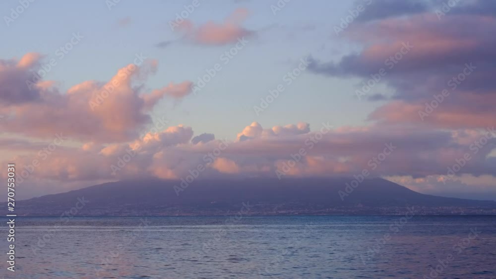 Mount Vesuvius timelapse with clouds rolling over its summit during sunset and view of mediterranean sea Mount Vesuvius timelapse with clouds rolling over its summit during sunset and view of mediterranean sea