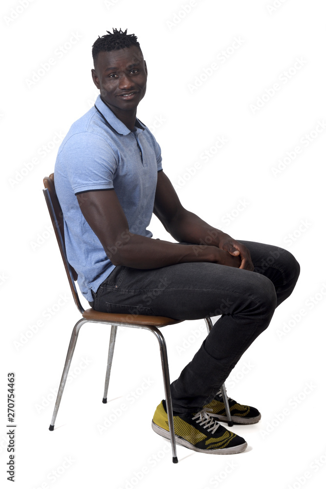 full portrait of african man sitting a chair on white background full portrait of african man sitting a chair on white background