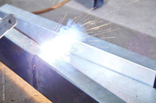 The welders are welding steel in the factory