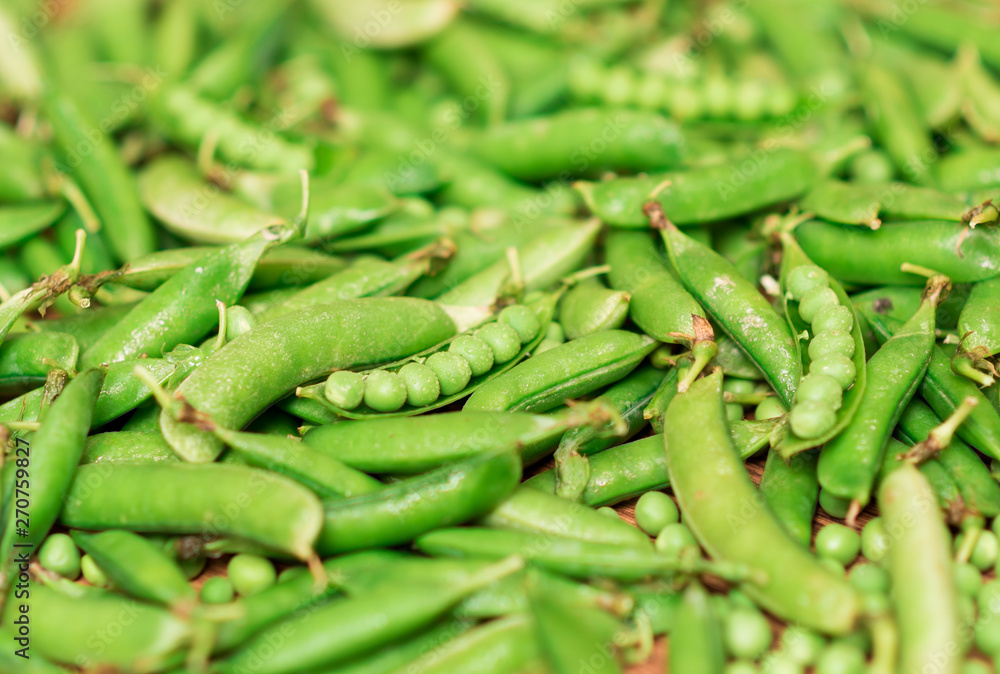 Green peas and pea pod on wood desk Green peas and pea pod on wood desk