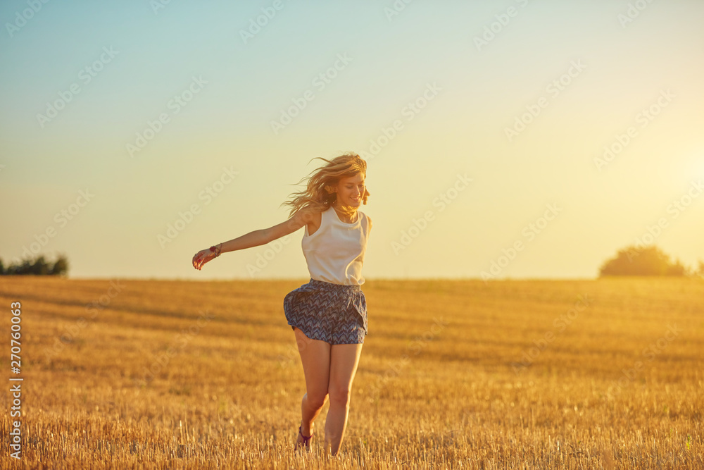 Cute young woman jumping in a wheat field. Cute young woman jumping in a wheat field.