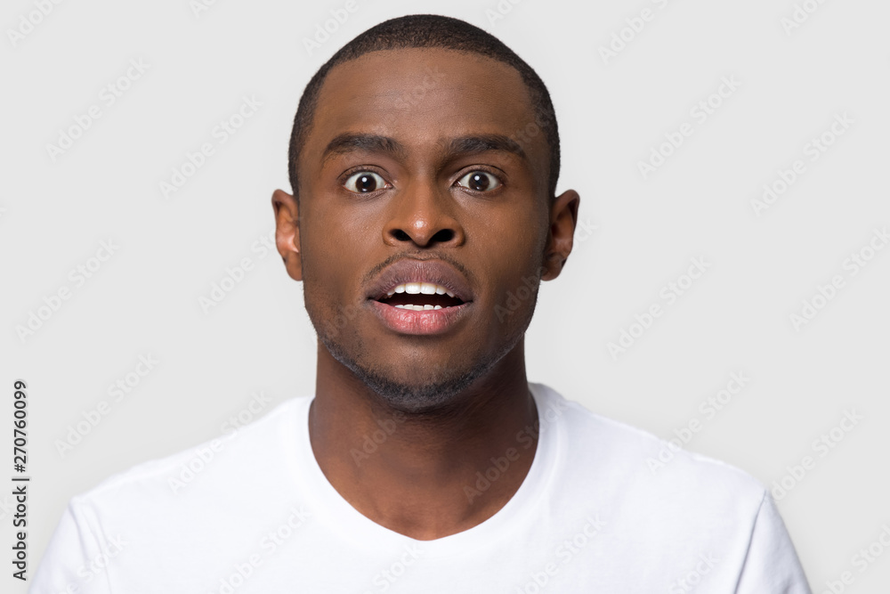 Portrait african man makes big eyes feels amazed studio shot Portrait african man makes big eyes feels amazed studio shot