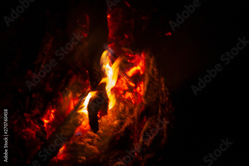 Flame bonfire. Open fire at night. Bonfire at night. Tourists are burning a fire. The fire is dangerous and burns. The texture of fire. Bonfire from wood. © Олег Копьёв