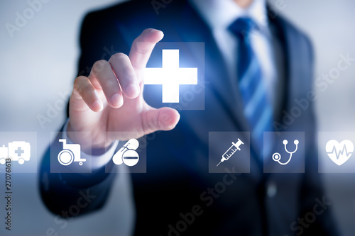 Fotografie Health insurance concept, Businessman holding Healthcare Medical icon